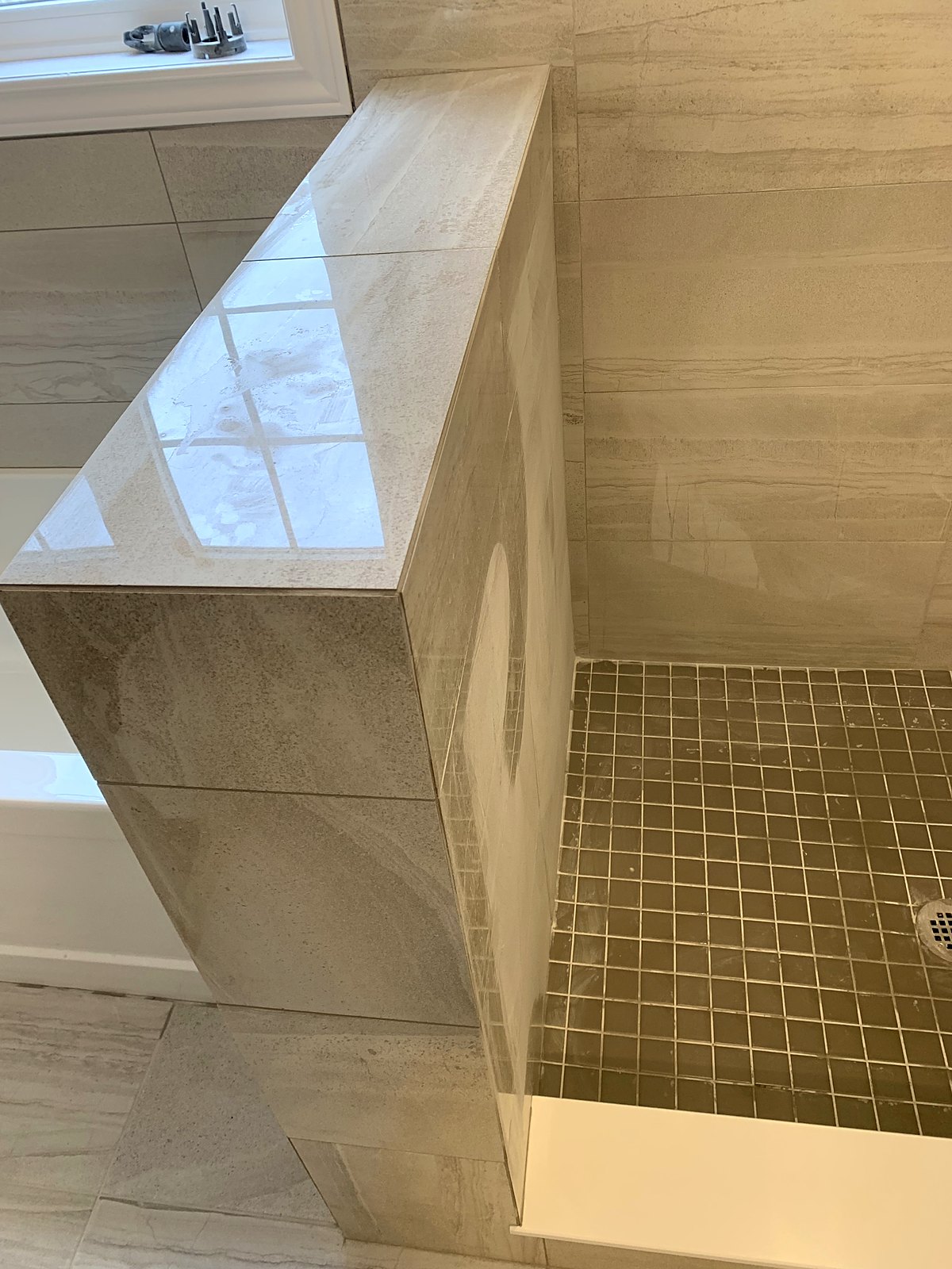 Walk-in shower with mosaic floor
